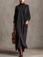 Marielle | Robe longue noire en faux daim avec surpiqûres rouges contrastées et poches plaquées